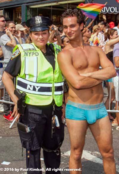 Man posing with one of New York's Finest on Gay Pride Day